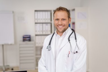 Smiling friendly doctor wearing a stethoscope clipart