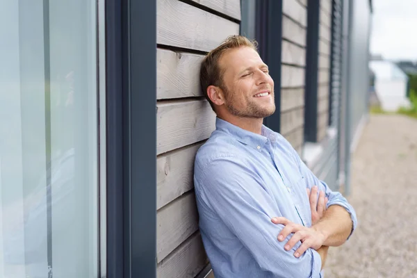 Confident young man with a satisfied expression — Stock Photo, Image