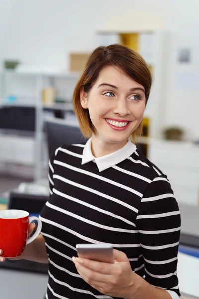 Smiling vivacious businesswoman taking a break — Stock Photo, Image