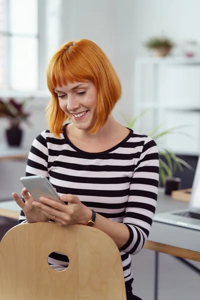 Heureuse jeune femme vérifiant ses messages téléphoniques — Photo