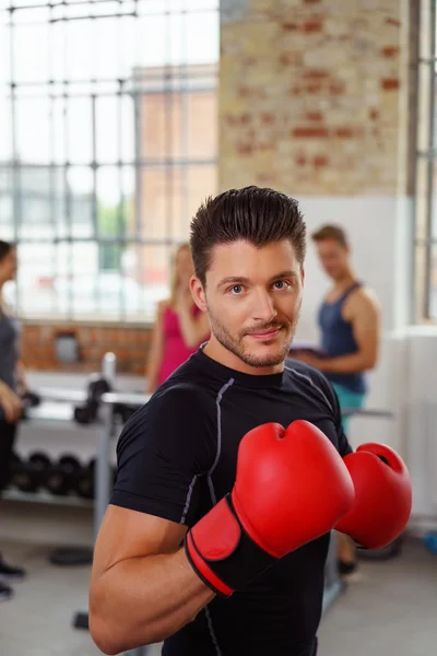 Muscular man using boxing gloves — Stock Photo, Image