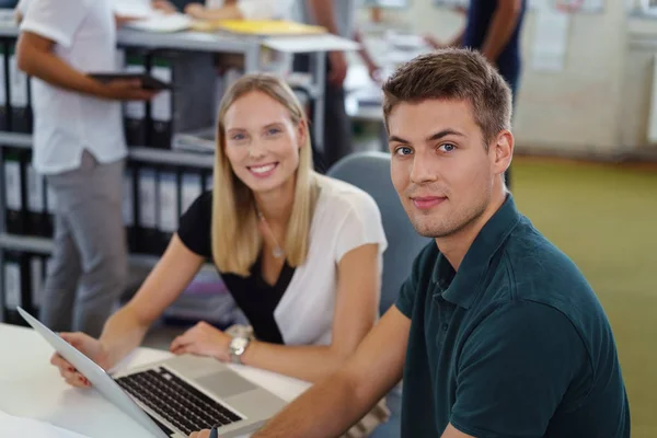 Young business man and woman working together