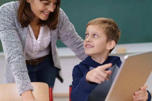 Jonge schooljongen in gesprek met de leraar — Stockfoto