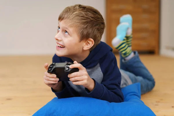 Young boy relaxing at home gaming — Stock Photo, Image