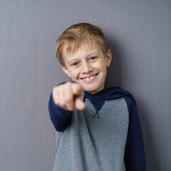 Grinning happy young boy pointing at the camera — Stock Photo, Image