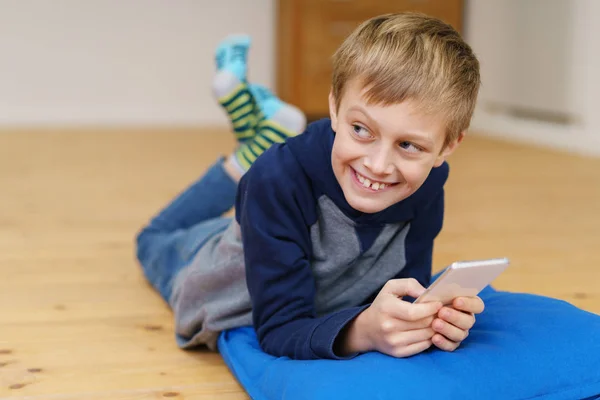 Cute young boy using a mobile phone — Stock Photo, Image