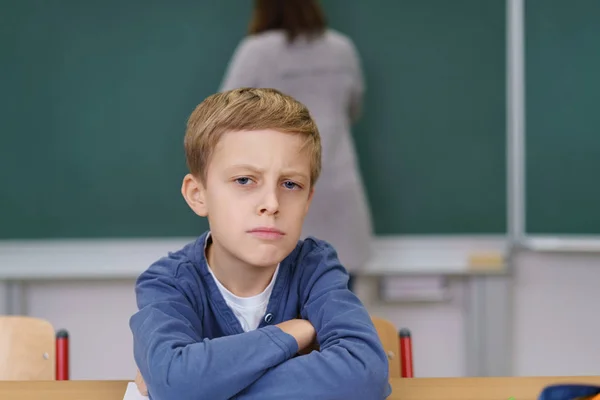 Thoughtful young boy scrutinising the camera — Stock Photo, Image