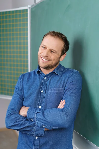 Teacher standing next to chalkboard — Stock Photo, Image