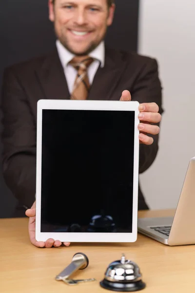 Hotel manager holding blank tablet — Stock Photo, Image