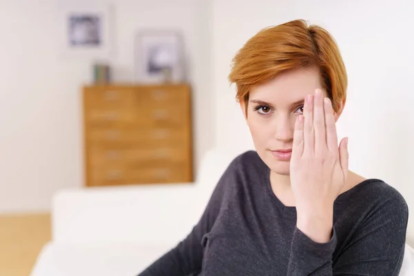 Woman covering an eye with hand — Stock Photo, Image