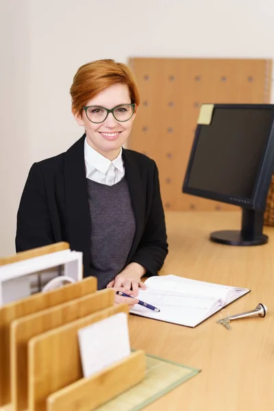 Young redhead hotel receptionist — Stock Photo, Image