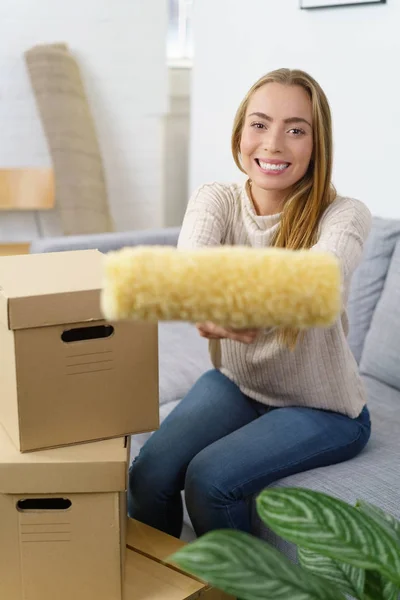 Woman holding paint roller — Stock Photo, Image