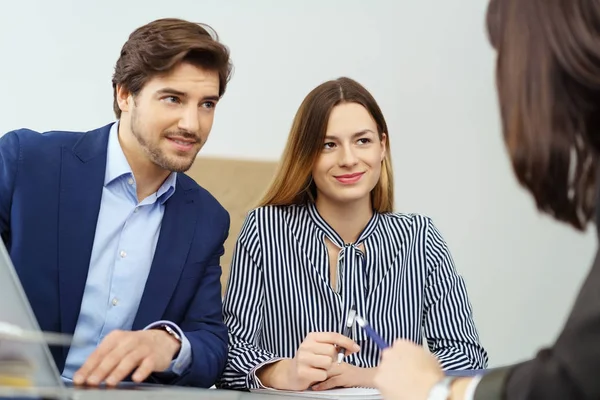 Mladý pár poslechu poradce nebo broker — Stock fotografie