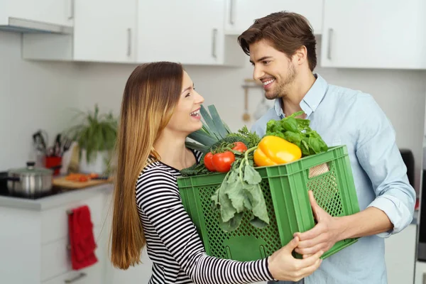 Laughing happy couple bringing in the groceries — Stock Photo, Image