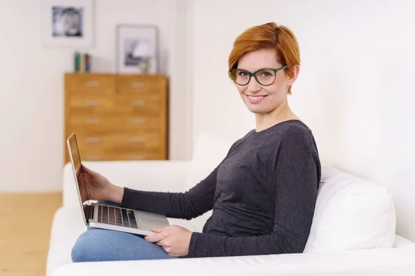Kobieta na kanapie z laptopem — Zdjęcie stockowe