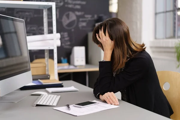 Depressed businesswoman with her head on her hand — Stock Photo, Image