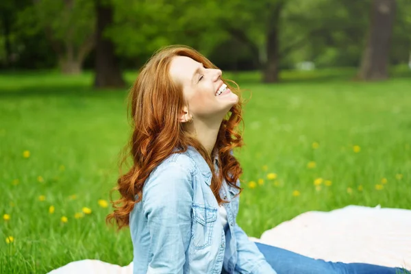 Happy young woman relaxing in the spring sunshine — Stock Photo, Image