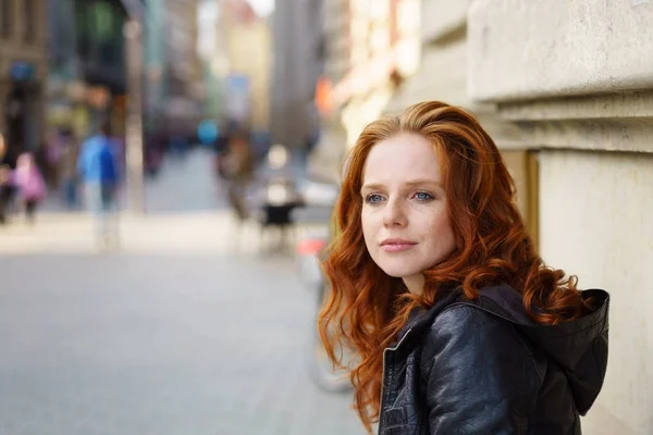 Thoughtful attractive woman standing watching — Stock Photo, Image