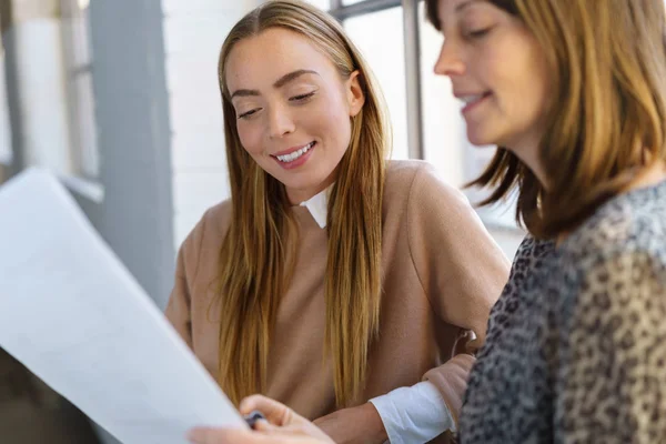 Two businesswomen discussing a document — Stock Photo, Image