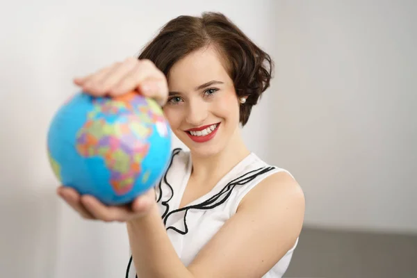 Pretty stylish young woman holding a globe — Stock Photo, Image