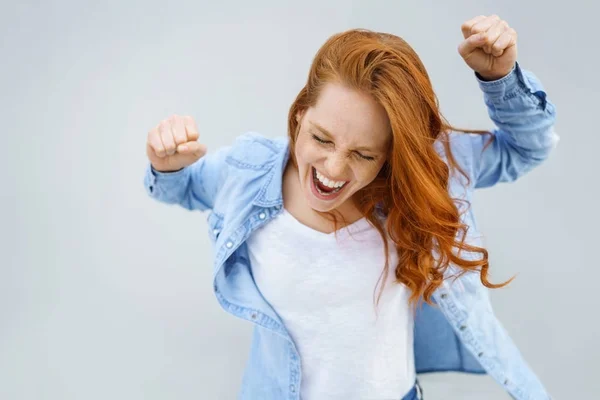 Excited exuberant young woman cheering