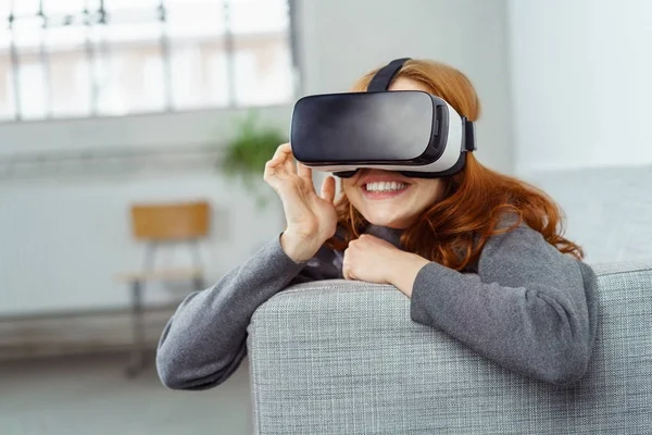 Szczęśliwa młoda kobieta korzystająca z zestawu słuchawkowego VR — Zdjęcie stockowe