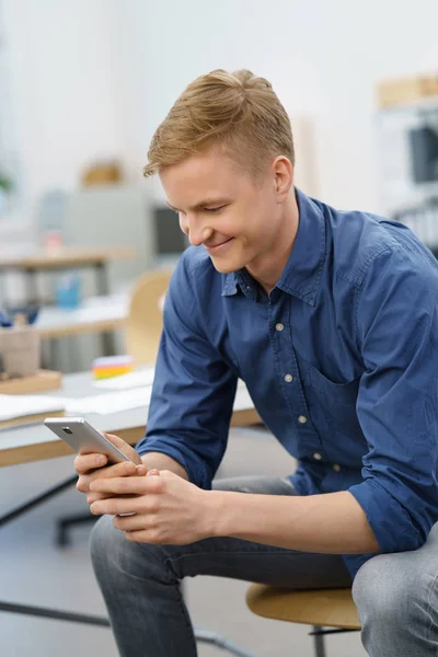 Junger Mann liest eine SMS — Stockfoto
