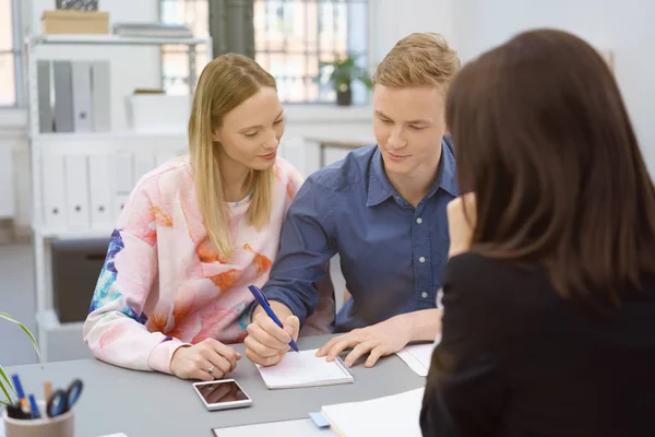 Young man signing a business proposal — Stock Photo, Image