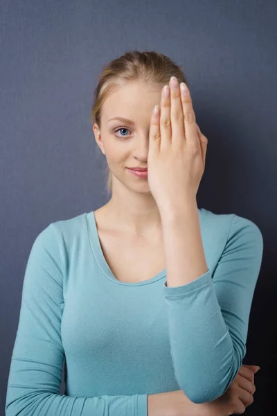 Attractive young woman covering on eye — Stock Photo, Image