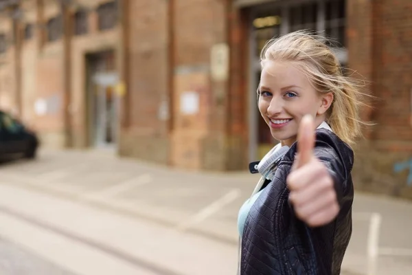 Cheerful young woman showing thumbs up — Stock Photo, Image