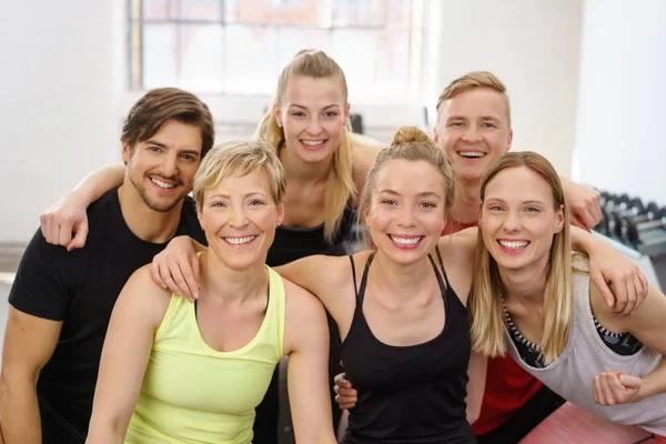 Group portrait of cheerful people at gym — Stock Photo, Image