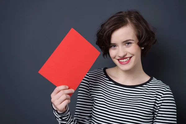 Cute pretty young woman holding a red card — Stock Photo, Image