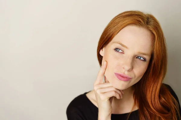 Nadenkend jonge vrouw op zoek opzij — Stockfoto