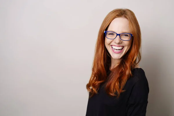 Vivacious young redhead woman wearing glasses — Stock Photo, Image