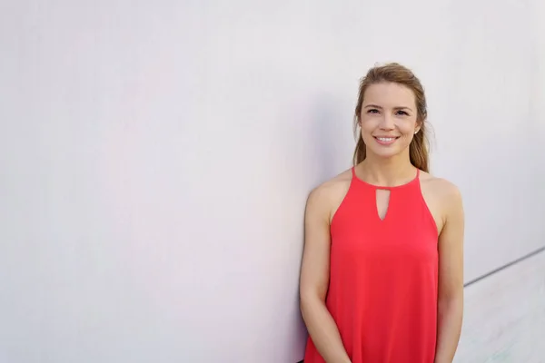 Pretty young woman in a bright red dress — Stock Photo, Image