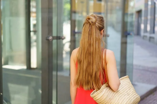 Young woman with long hair walking away — Stock Photo, Image