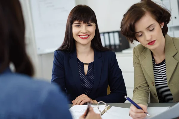 Smiling happy businesswoman in a meeting — Stock Photo, Image