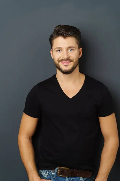 Young smiling man against black background — Stock Photo, Image