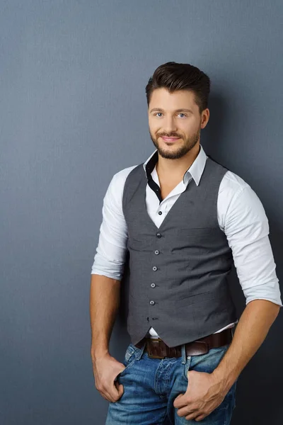 Young elegant man against dark background — Stock Photo, Image