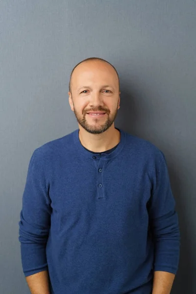 Hombre sonriente de pie sobre fondo gris — Foto de Stock