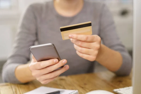 Woman contemplating making credit purchase — Stock Photo, Image