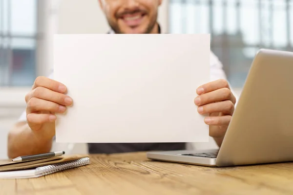 Businessman holding up blank white card — Stock Photo, Image