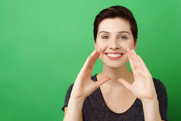 Woman putting hands against face to speak louder — Stock Photo, Image