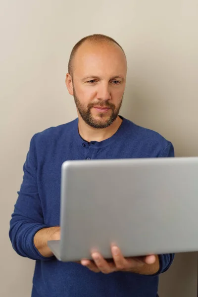 Щасливий бородатий чоловік використовує ноутбук — стокове фото