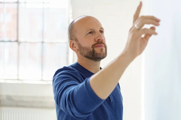 Thoughtful man pointing at something — Stock Photo, Image