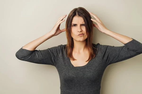 Charismatic Puzzled Young Woman Holding Her Hands Her Head Pulling — Stock Photo, Image