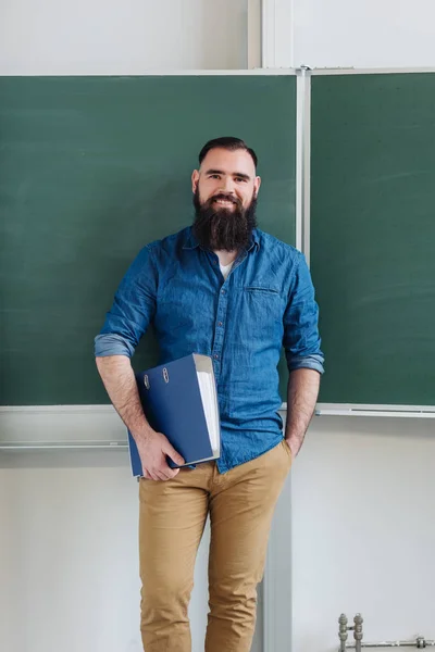 Relaxed Confident Male Teacher Classroom Standing Holding Binder Front Chalkboard — Stock Photo, Image