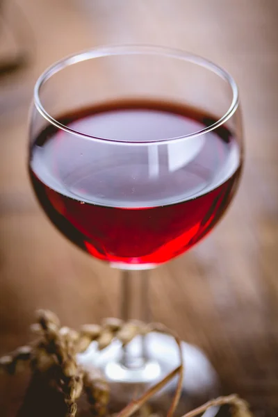 Glass of red wine on wooden table — Stock Photo, Image