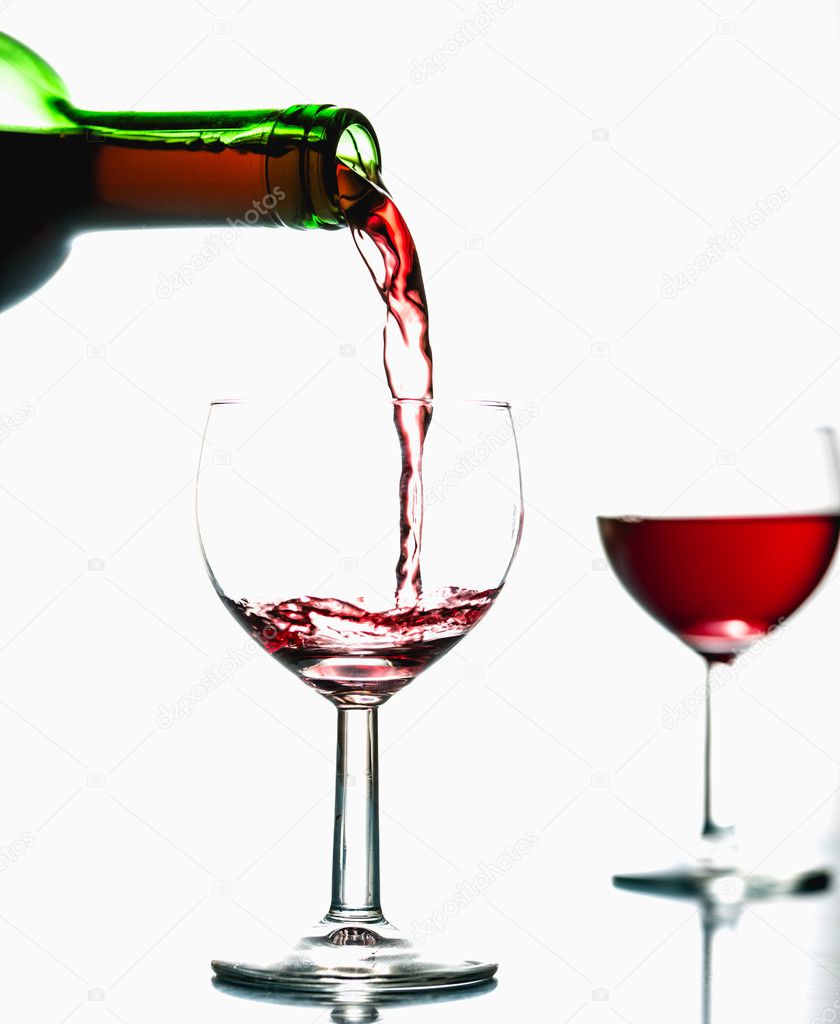 Pouring wine into the glasses, white background, isolated
