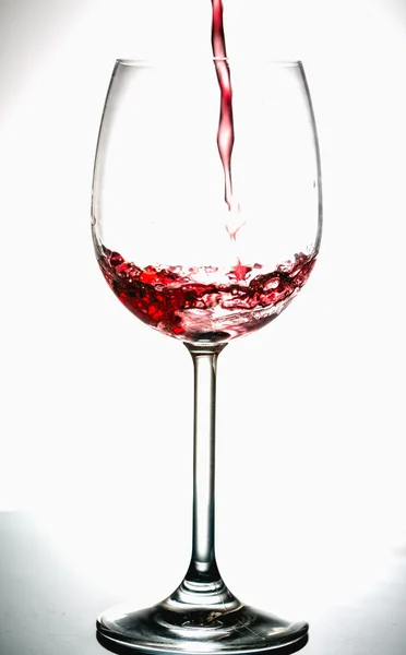 Pouring wine into the glasses, white background, isolated — Stock Photo, Image